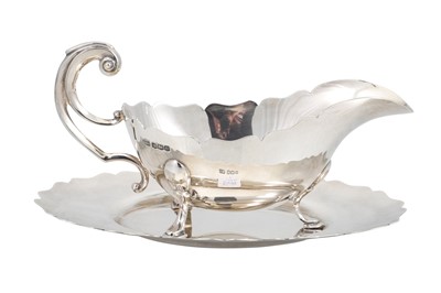 Lot 524 - A PRE-WAR GEORGE V SILVER HELMET SHAPED SAUCE...