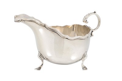 Lot 525 - A GEORGE V SILVER HELMET SHAPED SAUCE BOAT,...